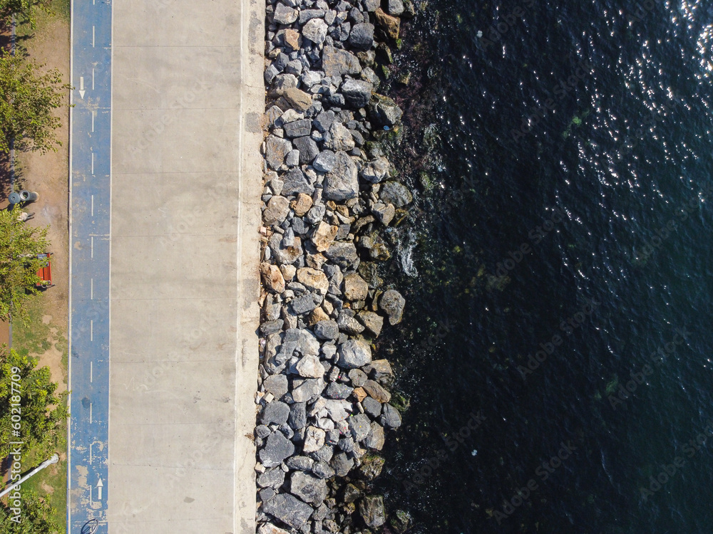 Large granite stones on the river bank. The edge of the river bank, water, road Large granite stones on the river bank. The edge of the river bank, water, road