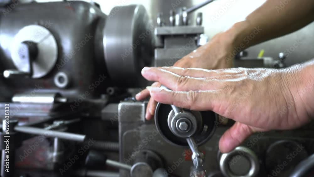 Dolly and pan shot of Turning lathe in action with cutting tool.
