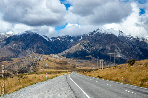 фотографія Snow capped mountains in prominence to a highway and power lines in Canterbury N
