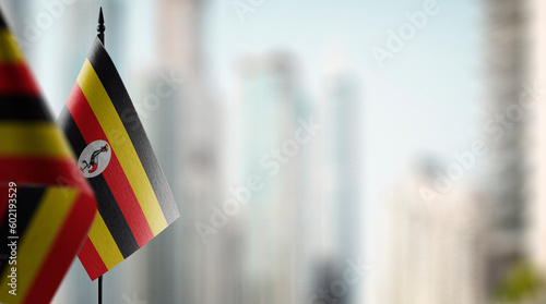 Small flags of the Uganda on an abstract blurry background