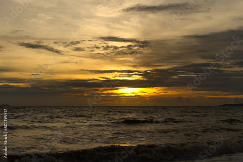 The sky with the orange light of the evening sun that is to sunset on the beach looks beautiful.