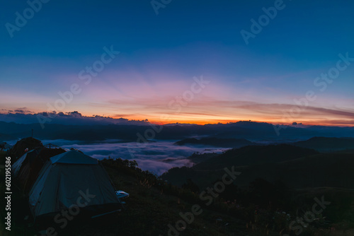Beautiful nature scenic sunrise foggy landscape Camping and tent on top view mountain outdoor vacation, Tourism destination.