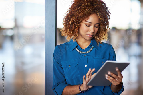 Corporate, young latino businesswoman with tablet and standing in office. Communication or networking, contact and mockup with black female worker on mobile device reading or writing email at work
