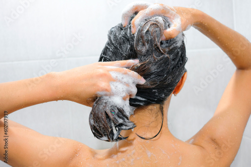 Beautiful woman's hand She was washing her hair and nourishing her scalp. Shampoo and conditioner