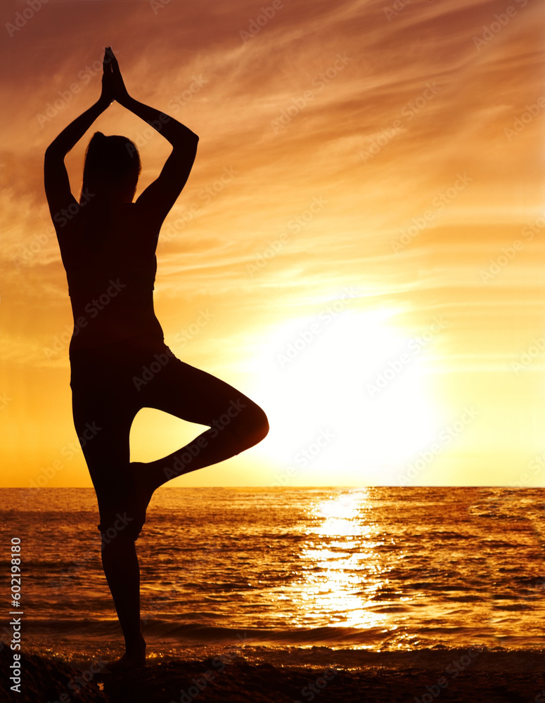 Silhouette, sunset and woman in tree pose with yoga on the beach, orange sky and fitness outdoor. Meditation, wellness and peace in nature with shadow, female yogi person and pilates by the ocean