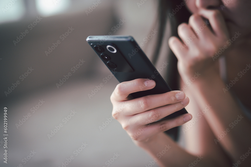 sad people casual wear sitting on sofa using call talking mobile phone during Symptoms unhappy female holding his forehead while having headache receive a bad news message. sad people casual wear sitting on sofa using call talking mobile phone during Symptoms unhappy female holding his forehead while having headache receive a bad news message.