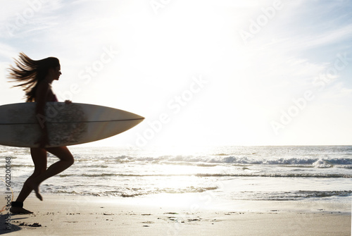 Silhouette  woman surfer run on beach sand and sea  exercise outdoor with surfboard to surf in nature. Sport  shadow and sun with female person running to ocean waves for surfing and mockup space