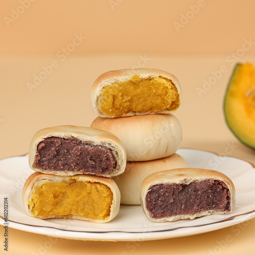 Cake made with purple sweet potato and pumpkin, moon cake, traditional Chinese pastry