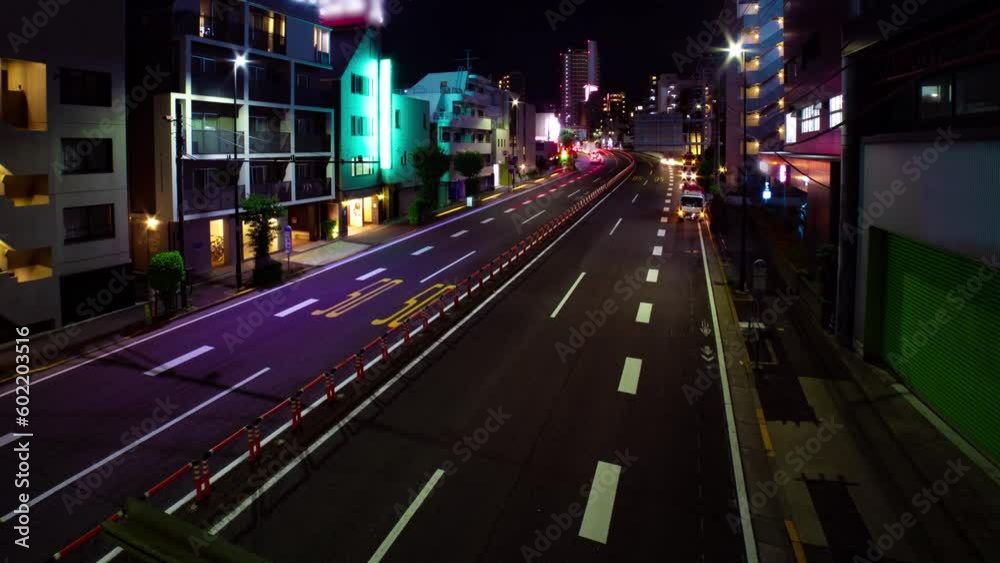 A night timelapse of the traffic jam at the urban city street wide shot panning A night timelapse of the traffic jam at the urban city street wide shot panning