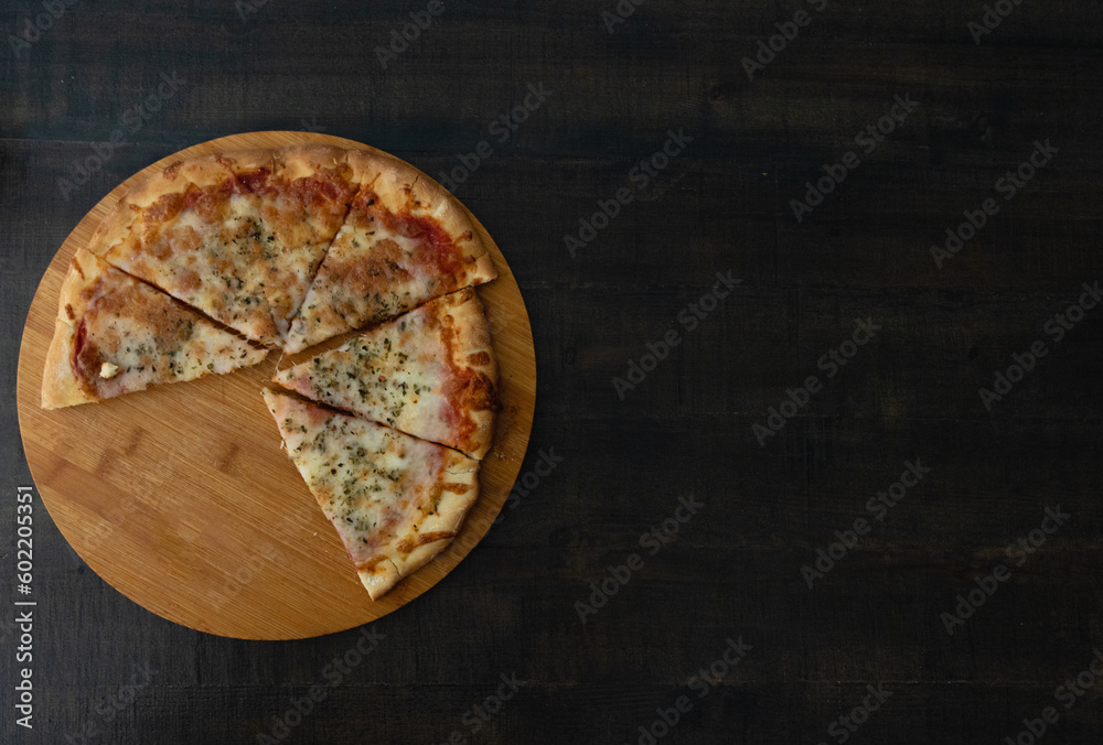 Tasty 4 cheese pizza on a wooden base