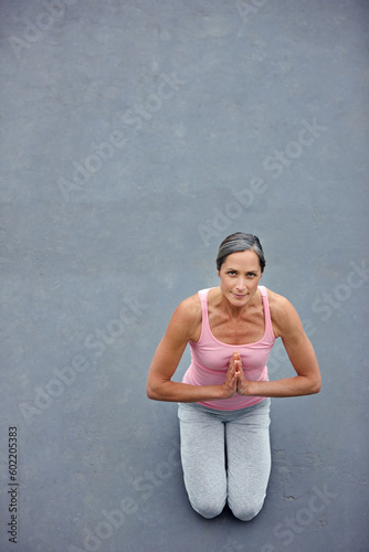 Yoga, mockup and portrait of old woman with praying hands on floor for meditation, healing and balance from above. Mindfulness, prayer pose and space for elderly lady meditating for zen or wellness © Laflor/peopleimages.com