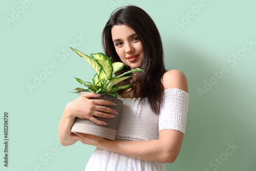 Young woman with houseplant...