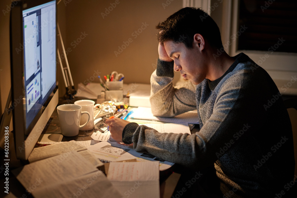 Man, studying and tired in night by computer for test, assessment or stress in college dorm room. Male university student, education and burnout with fear, fatigue and anxiety with books for learning Man, studying and tired in night by computer for test, assessment or stress in college dorm room. Male university student, education and burnout with fear, fatigue and anxiety with books for learning