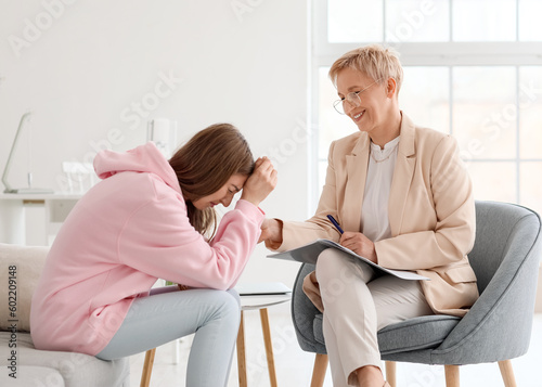 Mature psychologist working...
