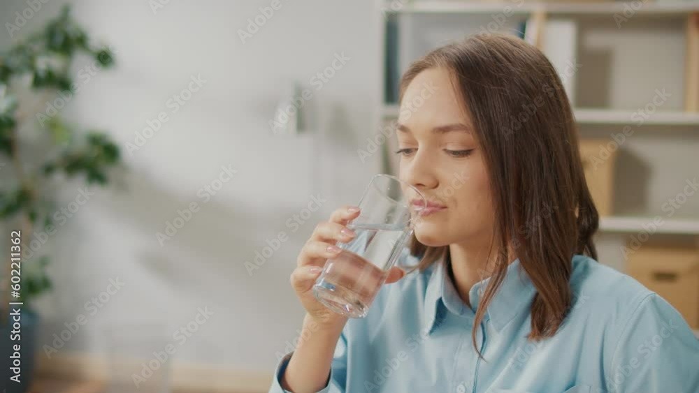 Female Office Worker Drink a Glass of Clean Water During a Break Between Work. Take Break Drink Natural Mineral Water Makes Sip Caring About Health, Prevents Dehydration. Everyday Routine Concept. Female Office Worker Drink a Glass of Clean Water During a Break Between Work. Take Break Drink Natural Mineral Water Makes Sip Caring About Health, Prevents Dehydration. Everyday Routine Concept.