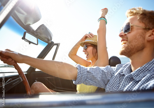 Travel, car road trip and profile couple on bonding holiday adventure, transportation journey or fun summer vacation. Love flare, convertible automobile and happy driver driving on Canada countryside photo