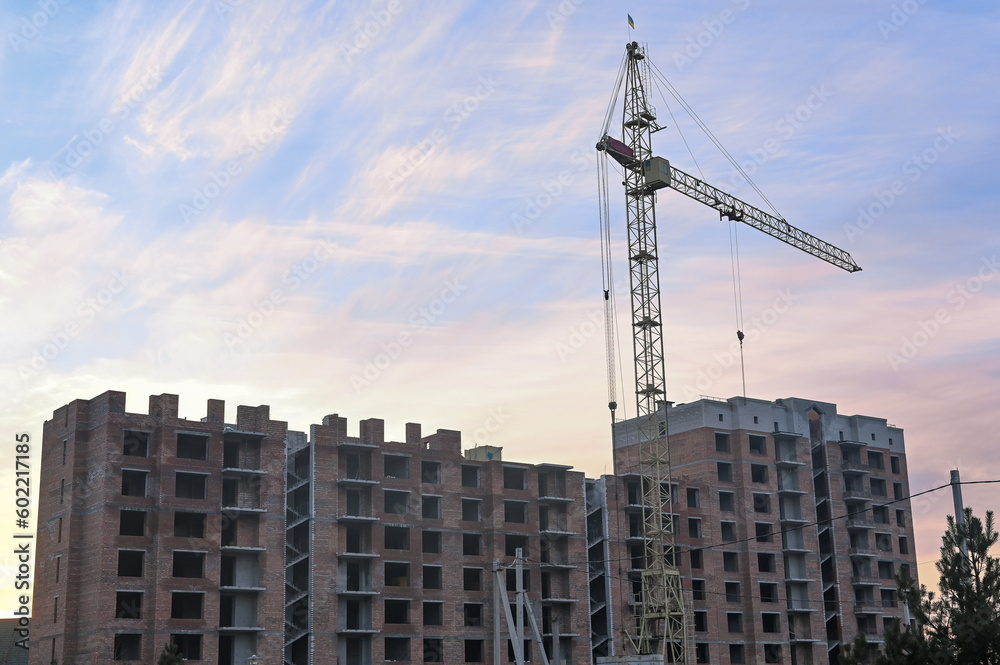 Fototapeta premium construction crane. against the background of a house under construction