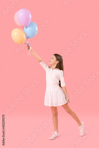 Little girl with balloons on pink background. Children's Day celebration