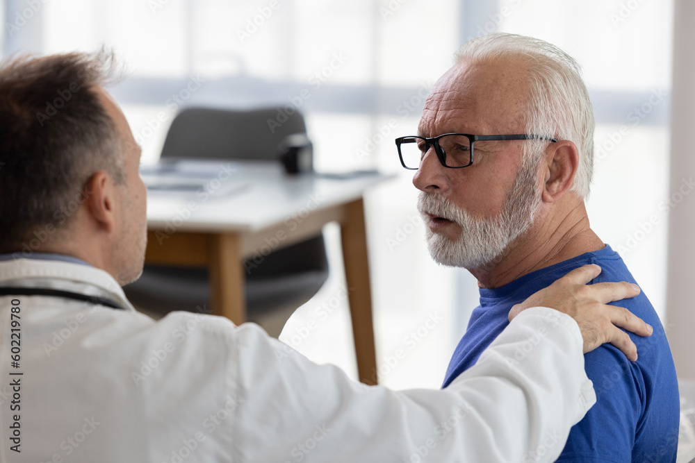 Doctor comforting and supporting sad senior patient having bad