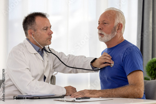Doctor cardiologist examining senior male patient by listening and checking heartbeat using stethoscope. Elderly people medicare, healthcare concept.