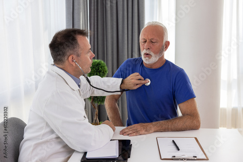 Doctor cardiologist examining senior male patient by listening and checking heartbeat using stethoscope. Elderly people medicare  healthcare concept.