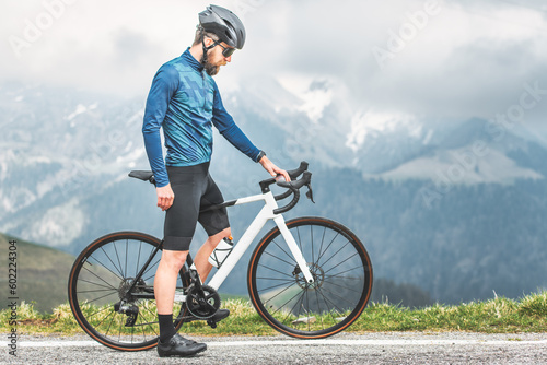 Cyclist standing on his bicycle