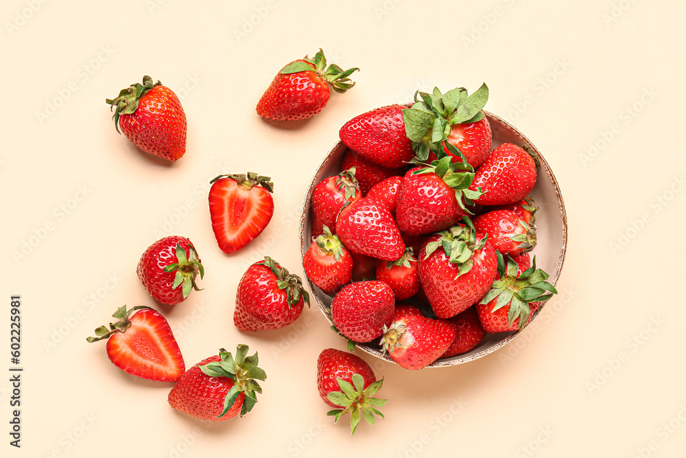 Bowl of fresh strawberries on beige background Bowl of fresh strawberries on beige background