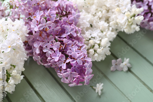 Beautiful fragrant lilac flowers on grey wooden background