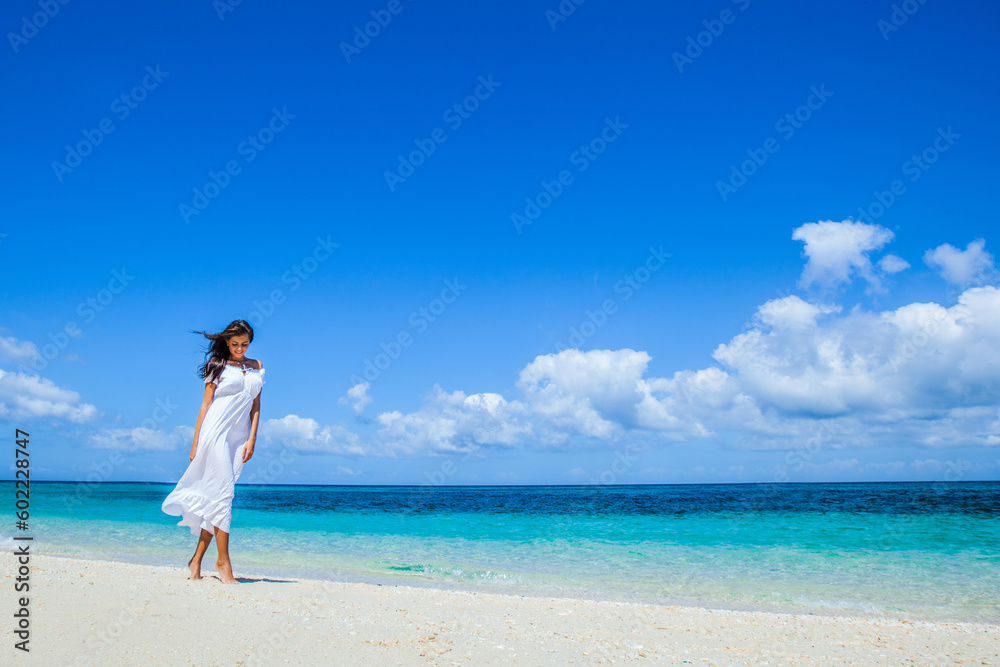 Woman walking along beach