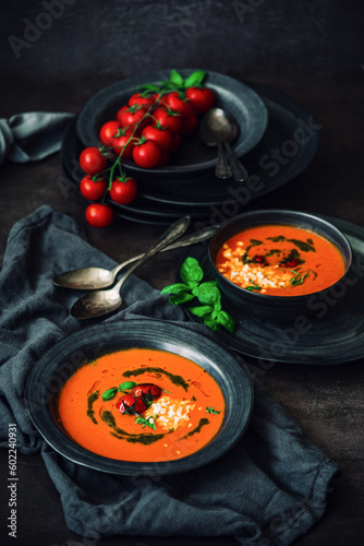 Fresh tomato soup with roasted tomatoes, feta cheese and basil pesto