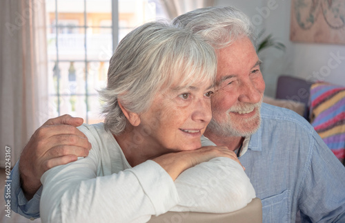 Loving old senior family couple bonding embracing. Happy nice elderly man and woman hugging while being in a great mood at home