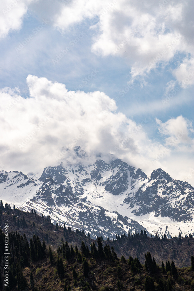 clouds over snowy mountain peaks. cloudy weather in the mountains