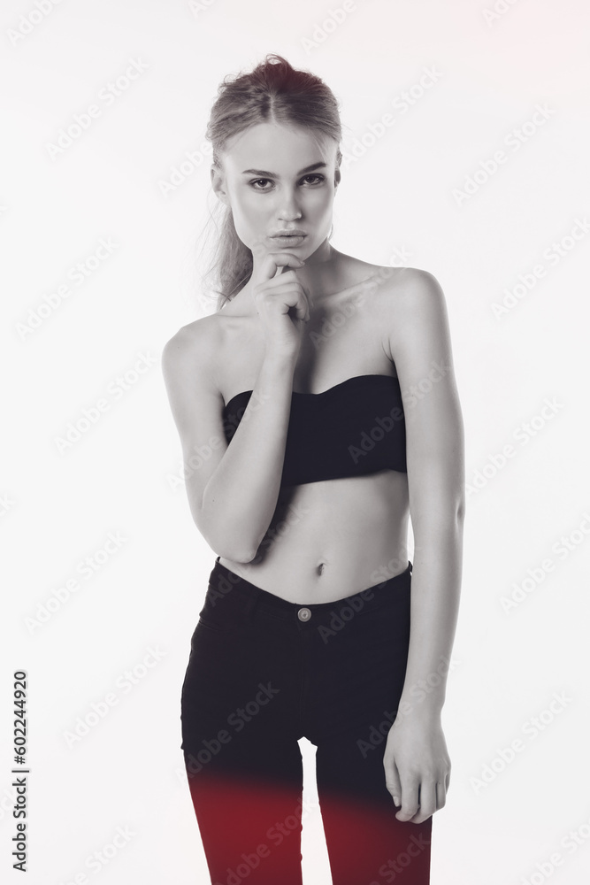 Naklejka premium Portrait, fashion and gen z girl in studio with confidence while posing against white background. Fashionable, face and young female person with attitude or trendy, cool and modern crop top clothing