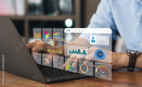 Business strategy concept for the development of the organization. Businessman use laptops to work on virtual smart digital screens, Analyze statistical Marketing data,Data management