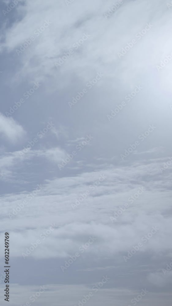 Cumulus clouds look like fluffy, white cotton balls in the sky. Beauty of Clouds. Vertical video. Cumulus clouds look like fluffy, white cotton balls in the sky. Beauty of Clouds. Vertical video.