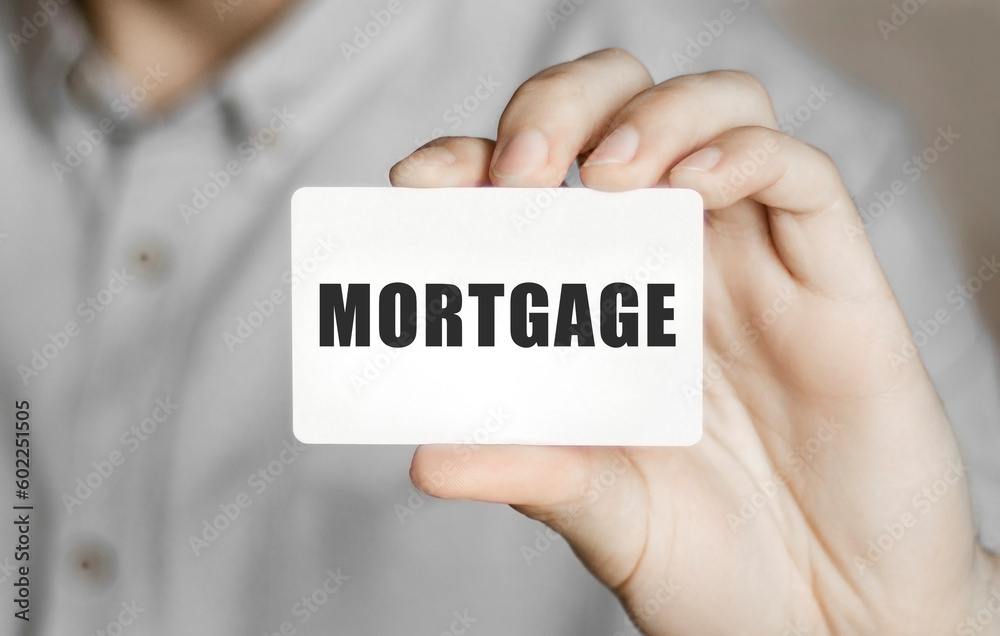 Card with text mortgage in a man's hand Card with text mortgage in a man's hand