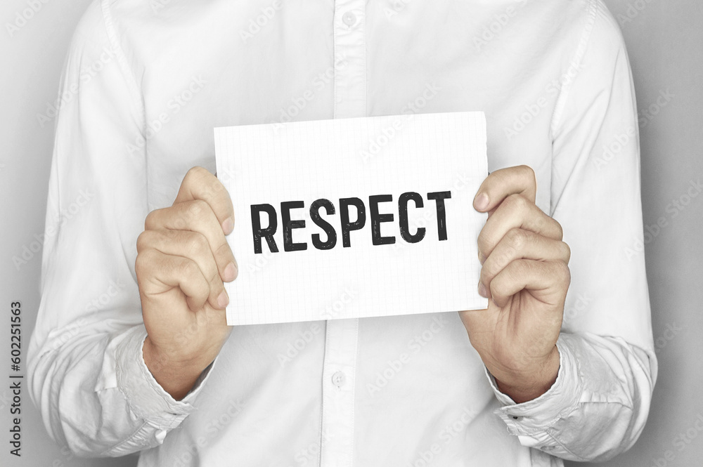 Man holding a paper card with text respect Man holding a paper card with text respect