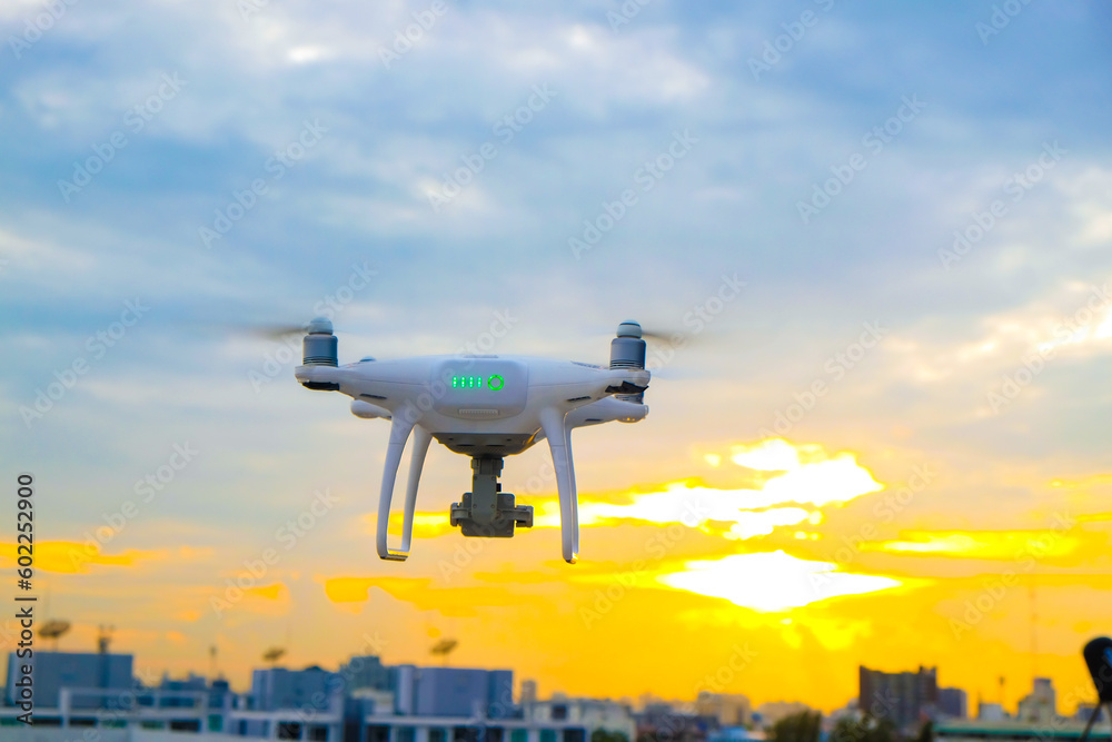 Delivery drone flying over city building sunset sky cloud Delivery drone flying over city building sunset sky cloud