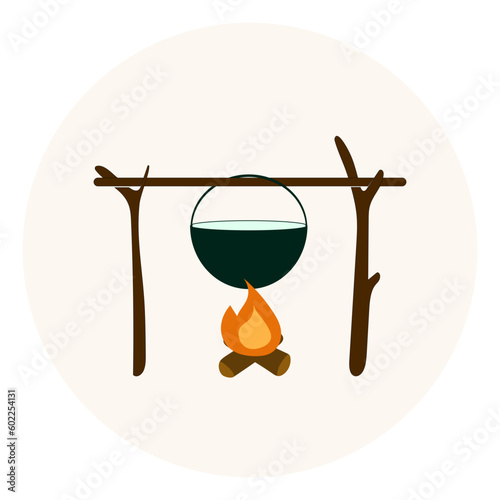 Cooking in a cauldron on campfire. Cauldron over campfire at camping 