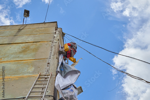 Rope access is a high-risk job. A man works on ropes.