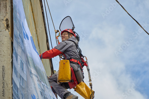 Wallpaper Mural Rope access is a high-risk job. A man works on ropes. Torontodigital.ca