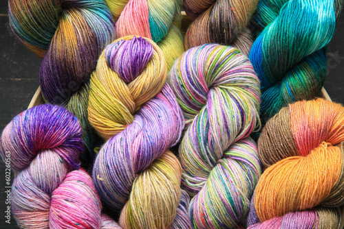 Multiple skeins of colourful handdied sock yarn, sock wool, with extreme vibrant colours for knitting socks and other craft projects as a hobby.