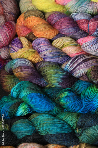 Multiple skeins of colourful handdied sock yarn, sock wool, with extreme vibrant colours for knitting socks and other craft projects as a hobby.