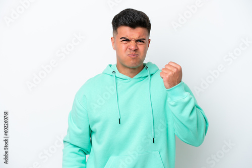 Young caucasian handsome man isolated on white background with unhappy expression © luismolinero