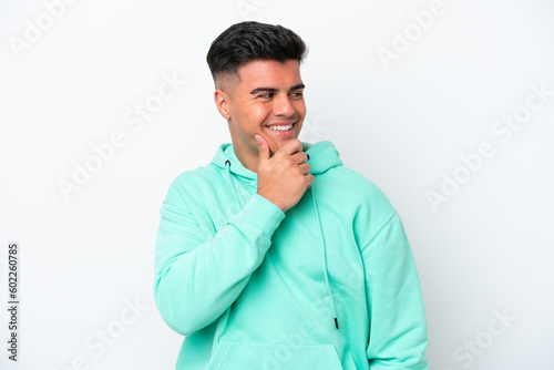 Young caucasian handsome man isolated on white background looking to the side and smiling