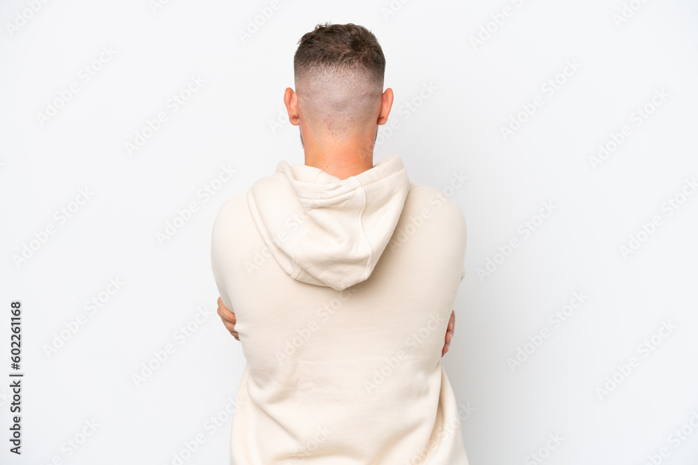 Young caucasian handsome man isolated on white background in back position Young caucasian handsome man isolated on white background in back position