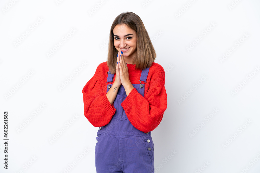 Young caucasian woman isolated on white background keeps palm together. Person asks for something Young caucasian woman isolated on white background keeps palm together. Person asks for something