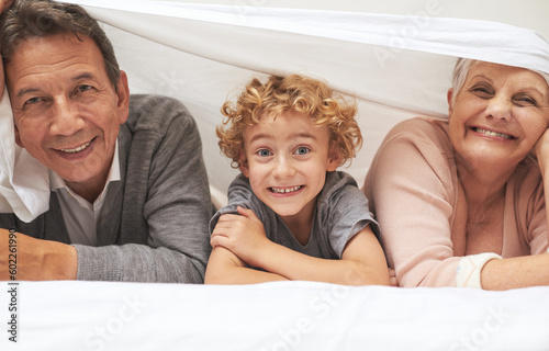 Portrait, grandparents or happy boy in bedroom to relax together for bonding in Australia with love at home. Morning, faces or grandmother with funny cute kid or old man to enjoy quality time on bed