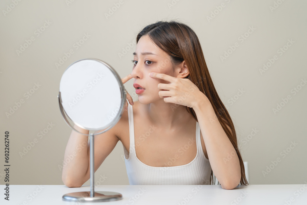 lack of sleep problem, Worried Asian young woman pointing finger at dark circles under her eyes lack of sleep problem, Worried Asian young woman pointing finger at dark circles under her eyes