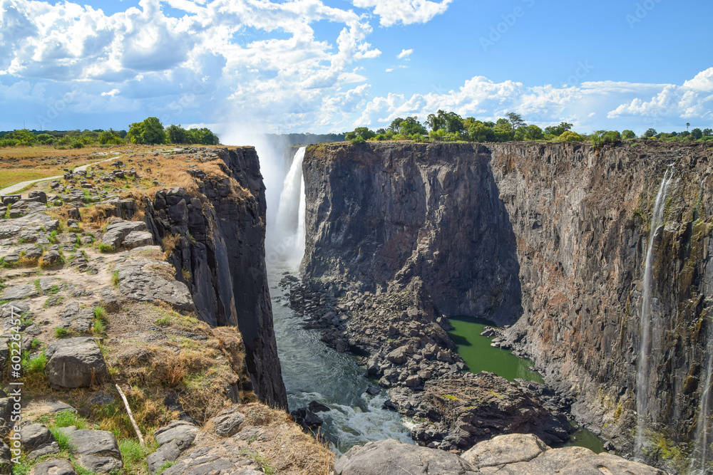 Parts of Mosi-Oa-Tunya waterfall aka Victoria Falls, during the dry season, view from the Zimbabwe side. - obrazy, fototapety, plakaty 